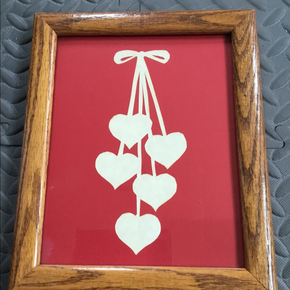 Handcrafted folk art hearts on red background